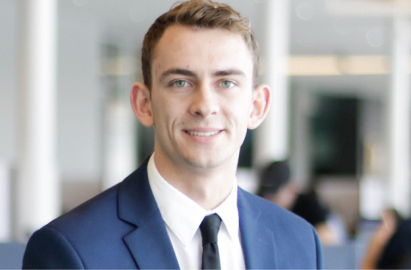 A young man in a business suit.